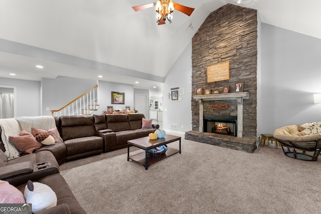 carpeted living room featuring high vaulted ceiling, a fireplace, and ceiling fan