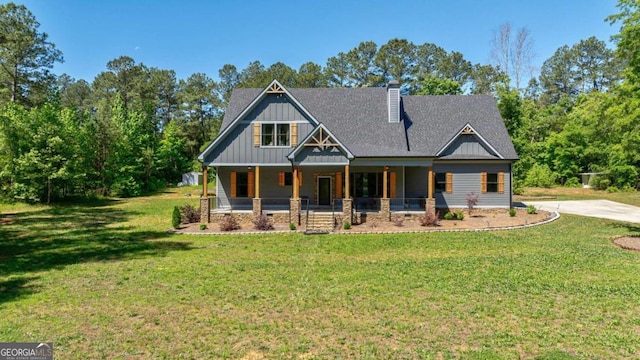 craftsman-style home featuring a front yard and covered porch