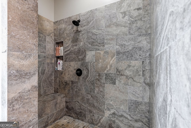 bathroom with tiled shower