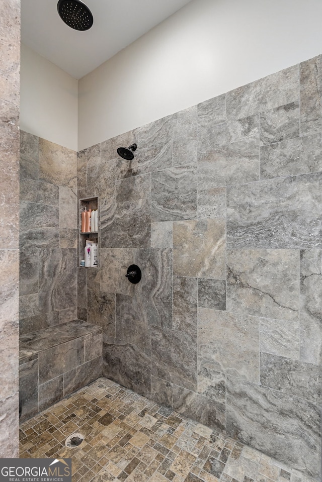 bathroom with a tile shower