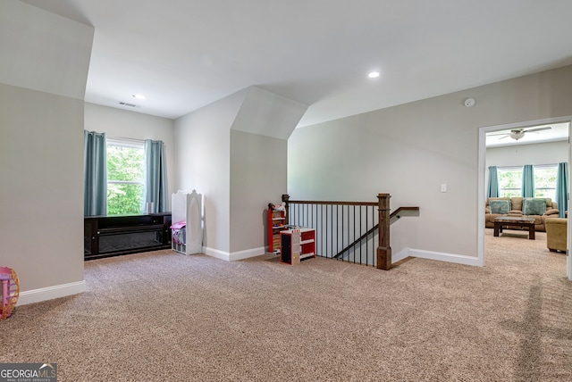 bonus room featuring plenty of natural light and carpet flooring