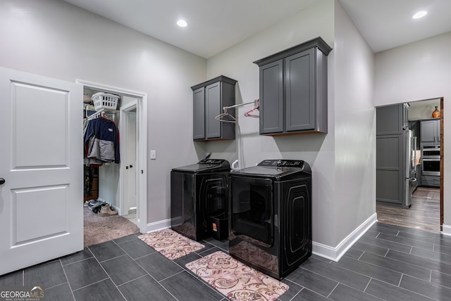 laundry room featuring cabinets and washing machine and clothes dryer