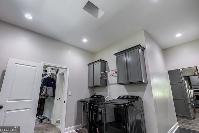 kitchen featuring gray cabinets, dark hardwood / wood-style flooring, washer and clothes dryer, and built in fridge