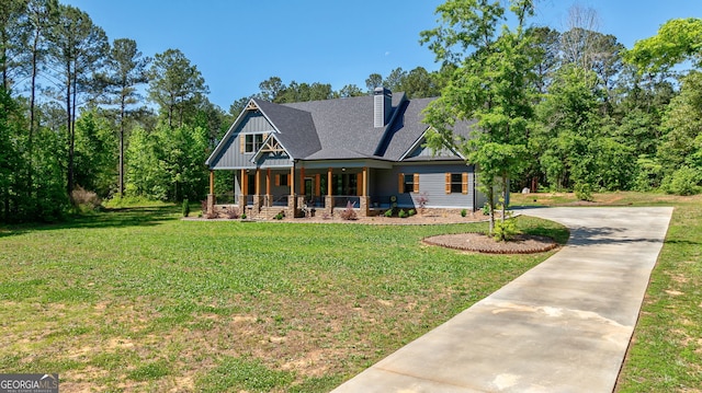 view of front of property with covered porch and a front yard