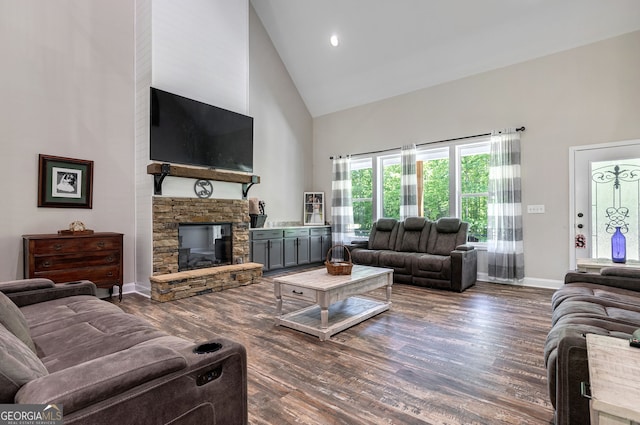 living room with a fireplace, dark wood-type flooring, and high vaulted ceiling