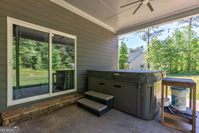 view of patio featuring ceiling fan and a hot tub