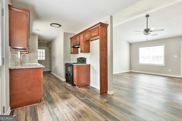 kitchen featuring black / electric stove, dark wood-type flooring, and vaulted ceiling