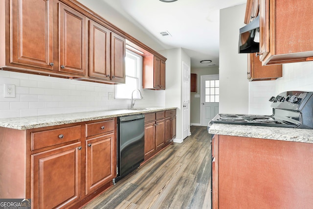 kitchen featuring dark wood-type flooring, black dishwasher, stainless steel range oven, and plenty of natural light