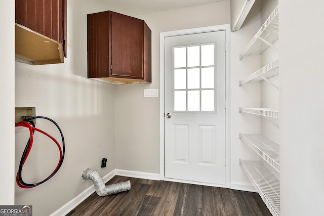 washroom featuring cabinets, washer hookup, and dark hardwood / wood-style flooring