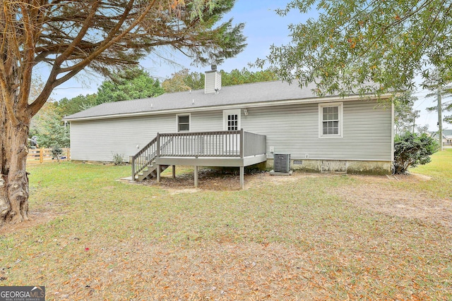 rear view of house with a wooden deck, a lawn, and central air condition unit