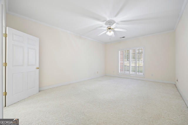 carpeted spare room featuring crown molding and ceiling fan