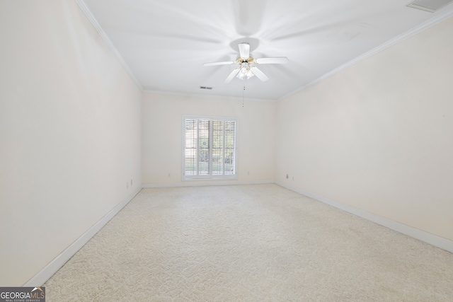 carpeted empty room featuring crown molding and ceiling fan