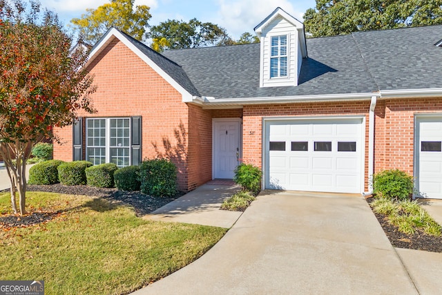 view of front of home featuring a front yard and a garage