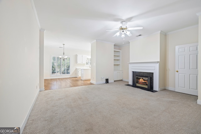 unfurnished living room featuring light carpet, crown molding, ceiling fan with notable chandelier, and a fireplace