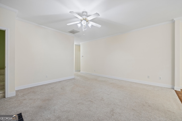 carpeted empty room featuring crown molding and ceiling fan