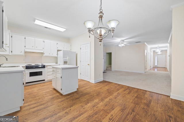 kitchen with white cabinetry, a kitchen island, pendant lighting, and white appliances