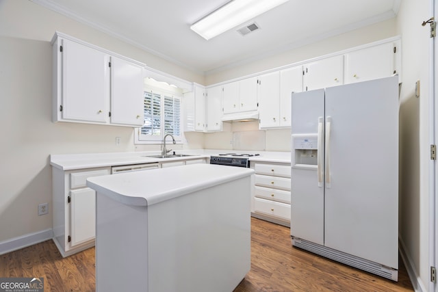 kitchen featuring dark hardwood / wood-style floors, sink, a center island, white cabinetry, and white appliances