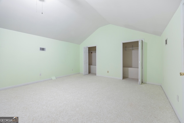 interior space with lofted ceiling and light colored carpet