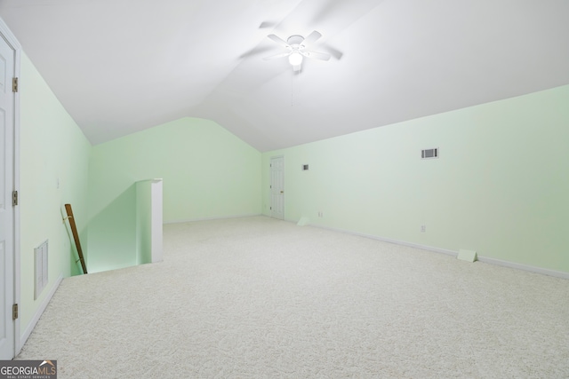 additional living space with light carpet, lofted ceiling, and ceiling fan