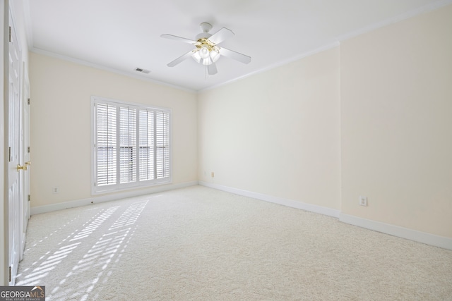 carpeted spare room featuring crown molding and ceiling fan