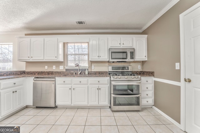 kitchen featuring white cabinets, visible vents, crown molding, stainless steel appliances, and a sink