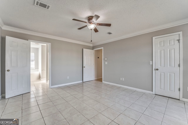 empty room featuring light tile patterned flooring, visible vents, crown molding, and a ceiling fan