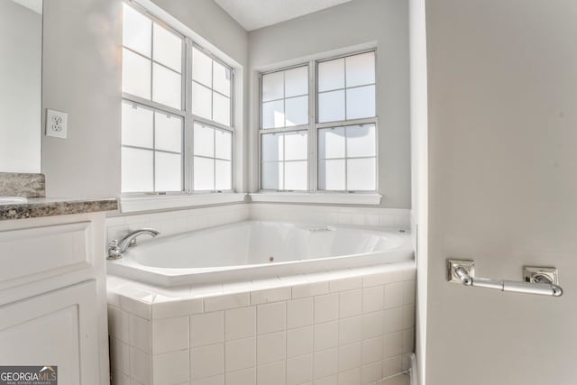 bathroom featuring a bath and vanity