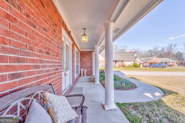 view of patio / terrace with covered porch and a residential view