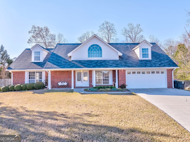 view of front of property featuring a front yard, concrete driveway, fence, brick siding, and a garage