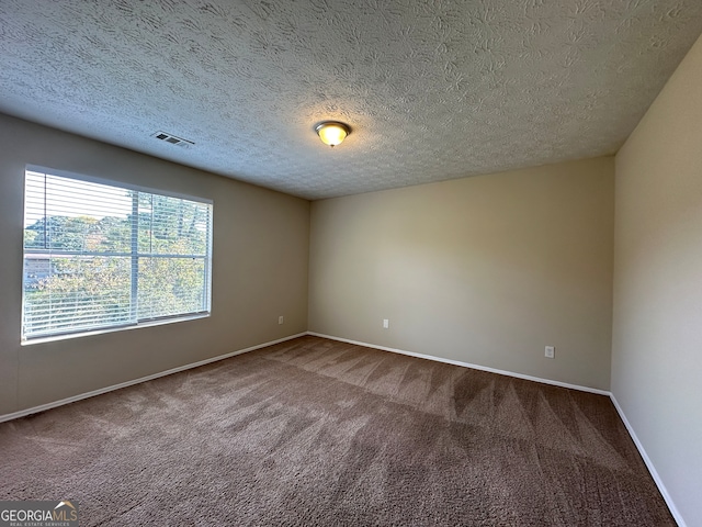 empty room featuring carpet floors and a textured ceiling