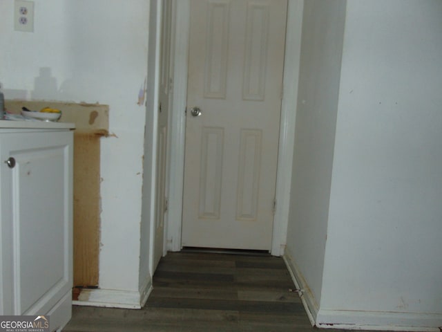 hallway with dark hardwood / wood-style flooring