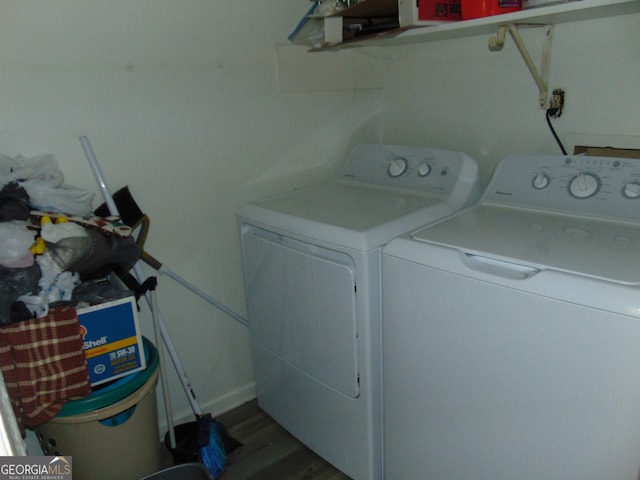 laundry room featuring washing machine and dryer and hardwood / wood-style floors