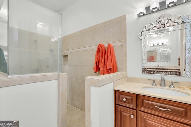 bathroom with vanity and a relaxing tiled tub