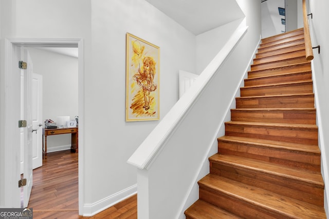 staircase with hardwood / wood-style flooring