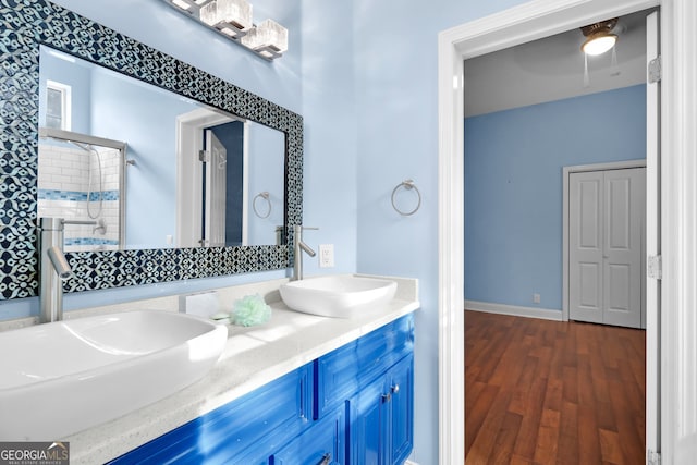 bathroom with vanity, an enclosed shower, and wood-type flooring