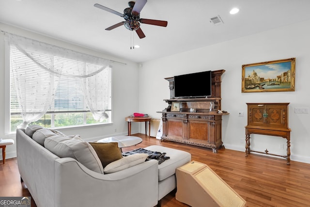 living room with hardwood / wood-style flooring and ceiling fan