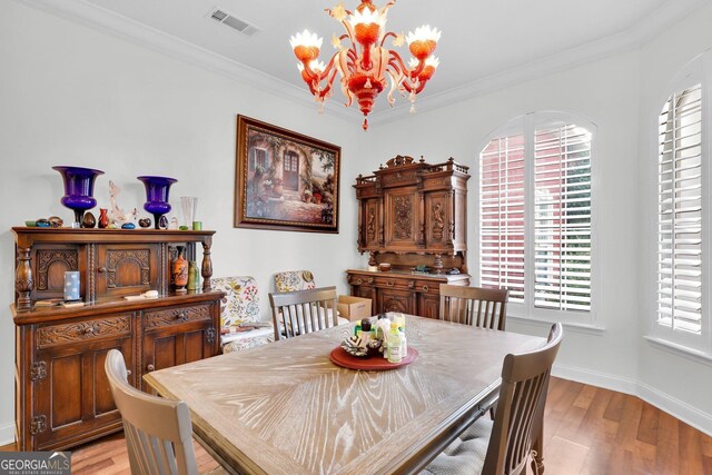 kitchen featuring white cabinetry, light stone countertops, sink, and hanging light fixtures