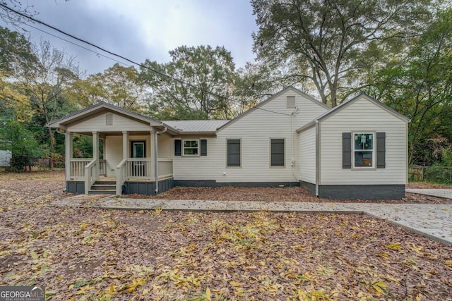 view of front of property with a porch and metal roof