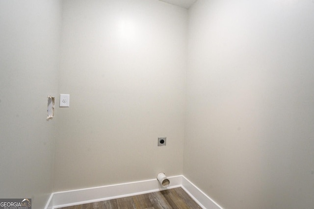 laundry area featuring laundry area, baseboards, dark wood-style flooring, and hookup for an electric dryer