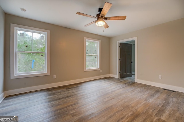 unfurnished room with ceiling fan and hardwood / wood-style flooring