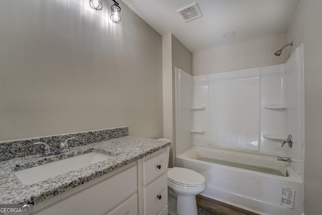 full bathroom with shower / tub combination, toilet, wood-type flooring, and vanity