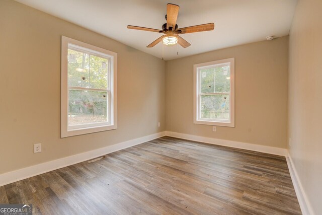 spare room with ceiling fan and wood-type flooring