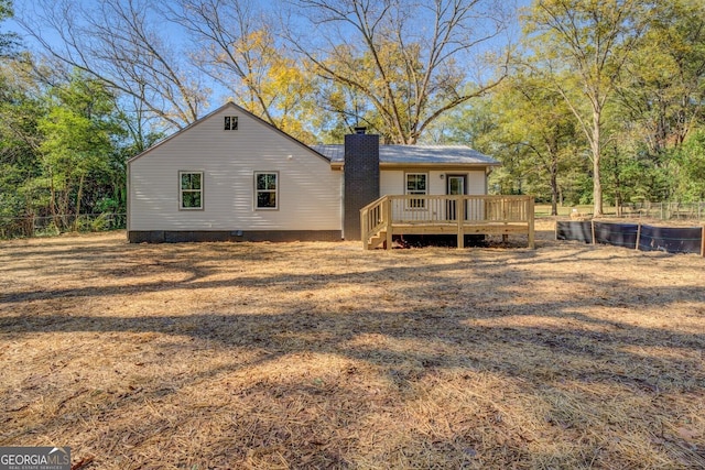 back of house featuring crawl space, a chimney, fence, and a deck