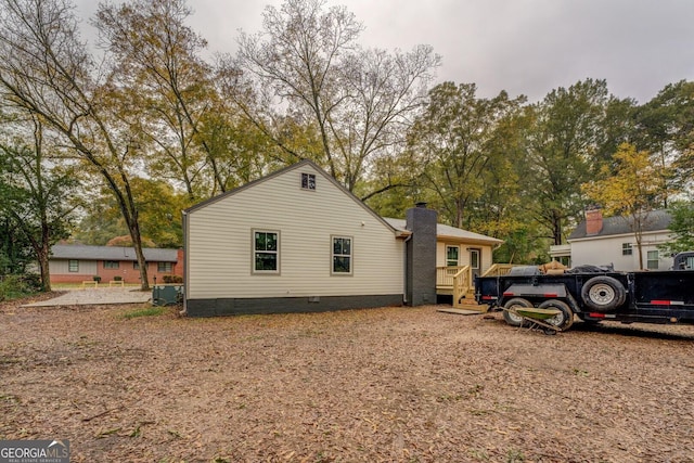 view of side of property featuring a wooden deck