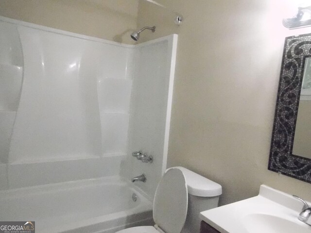 full bath with toilet, vanity, and shower / tub combination