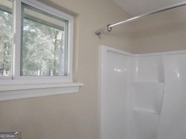 bathroom featuring a shower and healthy amount of natural light