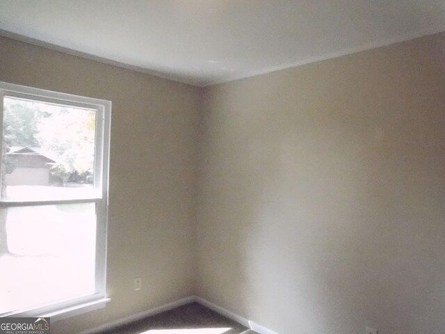 unfurnished room with baseboards