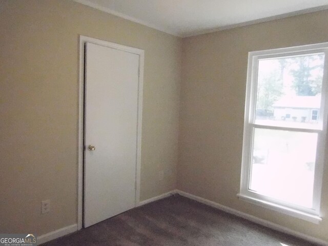 unfurnished room featuring baseboards