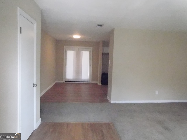 hallway with hardwood / wood-style floors