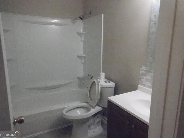 bathroom featuring vanity, toilet, and washtub / shower combination